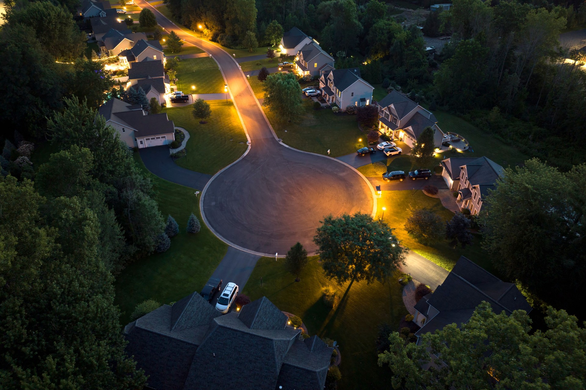 Aerial view of large private homes in Rochester, NY residential area at night. New family houses as example of real estate development in american suburbs